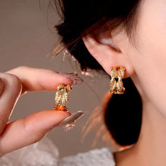 Model showcasing the dangle and style of the 14K Gold-Plated Elegant Double-Layer Zircon C-Shaped Earrings