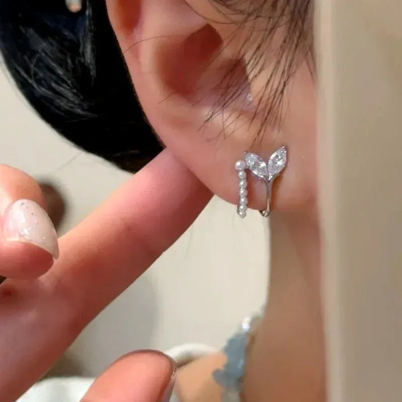 Model showcasing the dangle and style of the 14K Gold-Plated Elegant Double-Layer Zircon Fishtail Pearl Stud Earrings