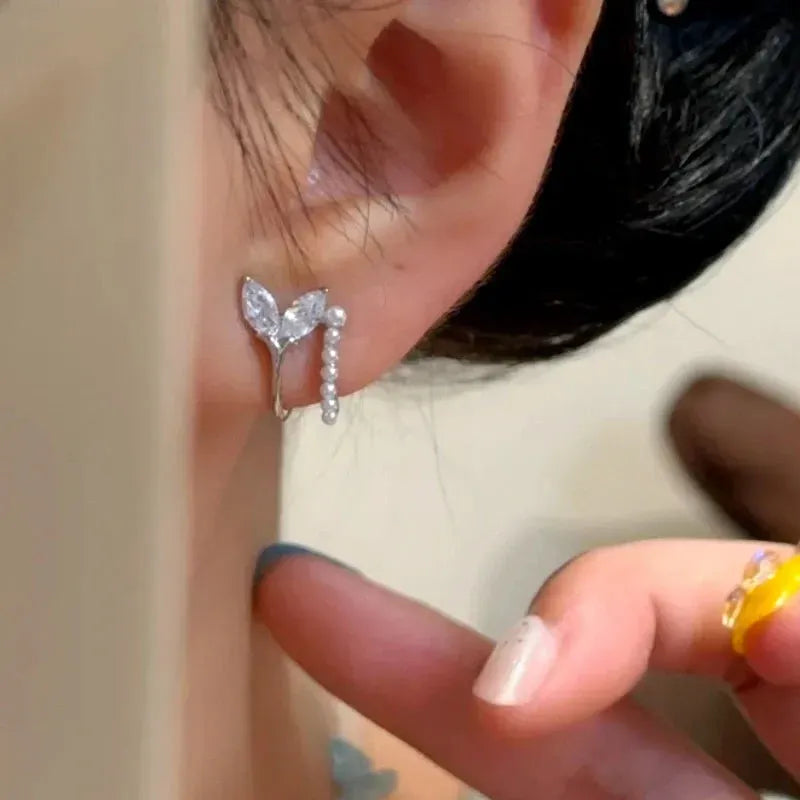 Close-up detail of the sparkling zircons and plating on the Fishtail Pearl Studs