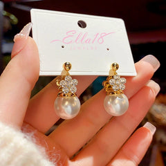 Angled view of the 14K Gold-Plated Elegant Double-Sided Flower Pearl Earrings