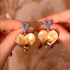 Model showcasing the dangle and style of the 14K Gold-Plated Elegant Double Love Gradient Crystal Earrings