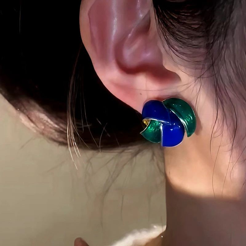 Model showcasing the dangle and style of the 14K Gold-Plated Elegant Enamel Blue And Green Stud Earrings