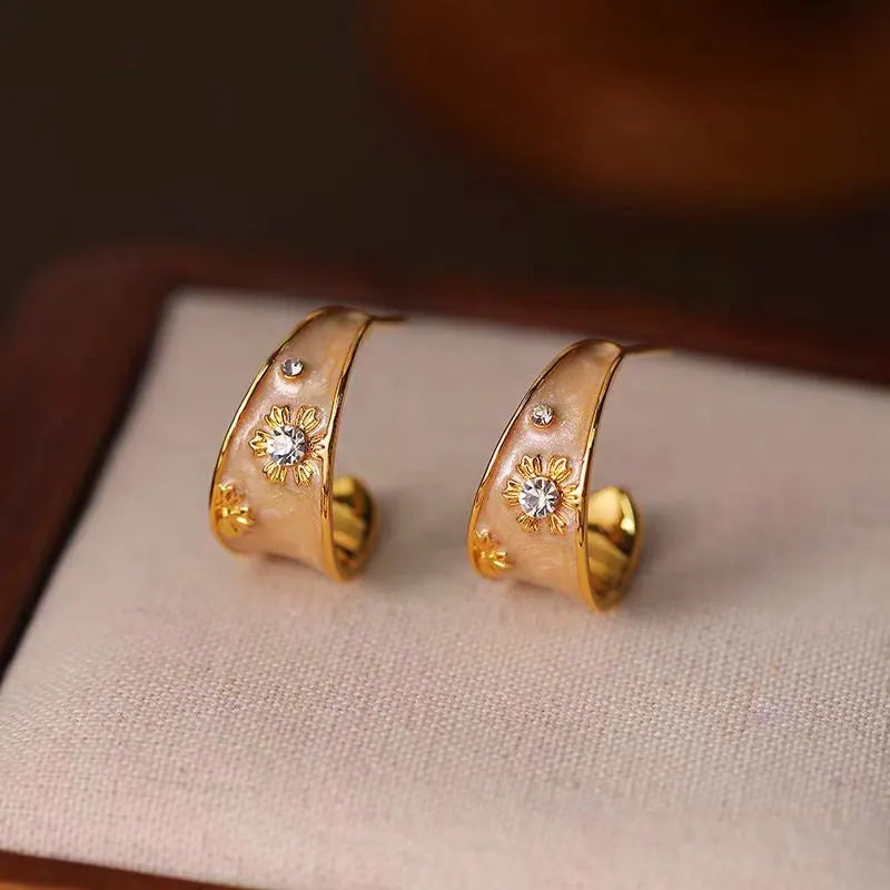 Close-up detail of the sparkling zircons and plating on the Enamel Flower Earrings