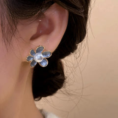 Model showcasing the dangle and style of the 14K Gold-Plated Elegant Enamel Flower Pearl Stud Earrings