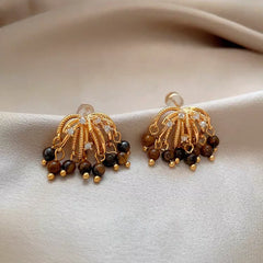 Angled view of the 14K Gold-Plated Elegant Firework Tassel Earrings