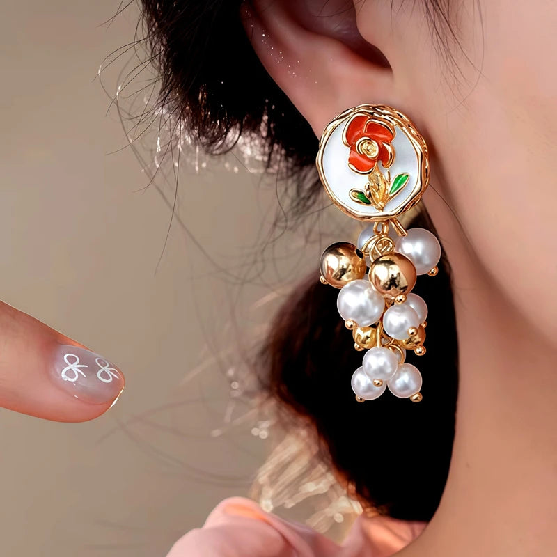 Model showcasing the dangle and style of the 14K Gold-Plated Elegant Flower Bead Tassel Earrings