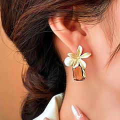 Model showcasing the dangle and style of the 14K Gold-Plated Elegant Flower Pearl Crystal Earrings