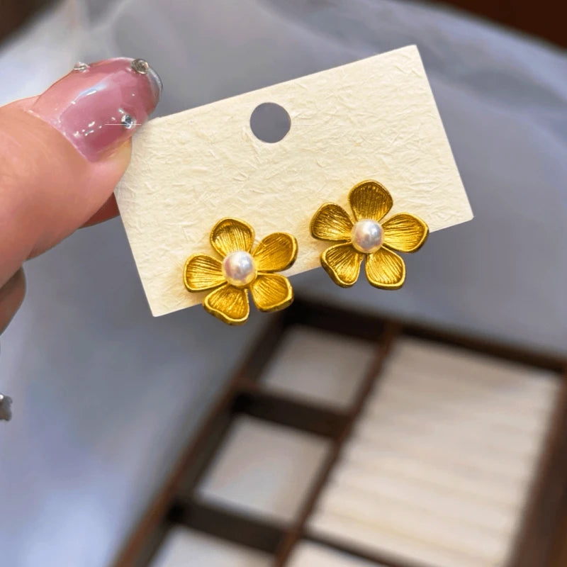 Angled view of the 14K Gold-Plated Elegant Flower Pearl Stud Earrings