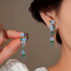 Model showcasing the dangle and style of the 14K Gold-Plated Elegant Flower Tassel Earrings