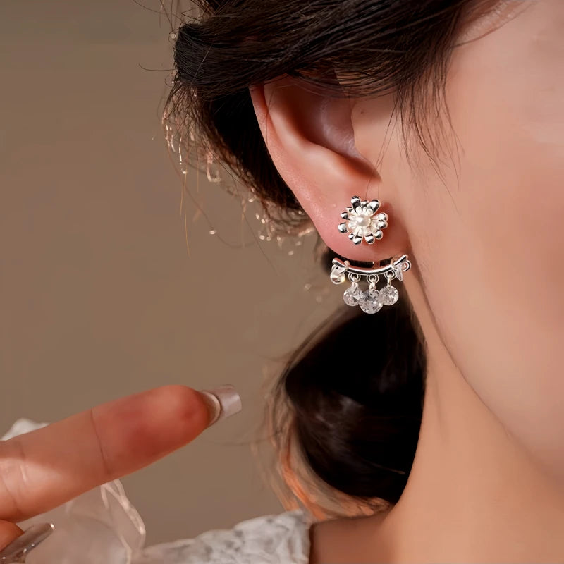 Model showcasing the dangle and style of the 14K Gold-Plated Elegant Flower Zircon Tassel Earrings