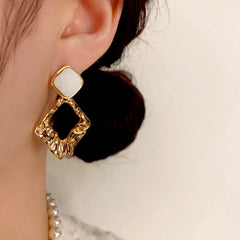 Close-up detail of the sparkling zircons and plating on the Geometric Diamond Earrings