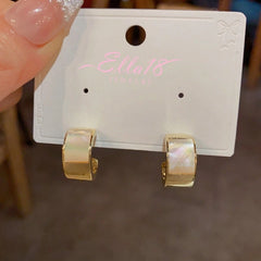 Close-up detail of the sparkling zircons and plating on the Shell C-Shaped Earrings