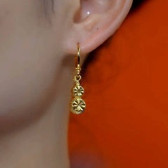 Model showcasing the dangle and style of the 14K Gold-Plated Elegant Gourd Earrings