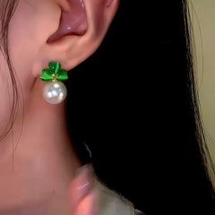 Model showcasing the dangle and style of the 14K Gold-Plated Elegant Green Cat's Eye Stone Three-Leaf Flower Pearl Earrings