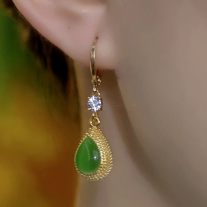 Model showcasing the dangle and style of the 14K Gold-Plated Elegant Green Crystal Durian Earrings