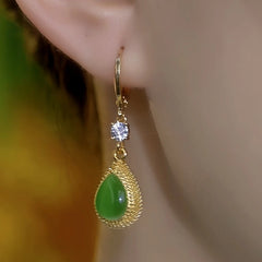 Model showcasing the dangle and style of the 14K Gold-Plated Elegant Green Crystal Durian Earrings