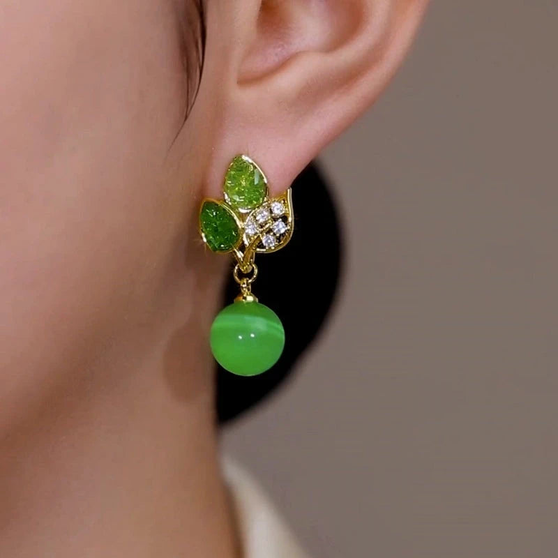Close-up detail of the sparkling zircons and plating on the Green Leaf Earrings