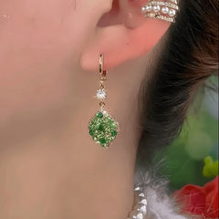 Close-up detail of the sparkling zircons and plating on the Green Water Drop Earrings