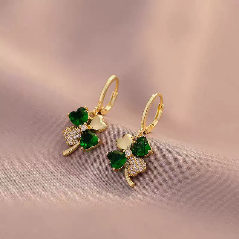 Model showcasing the dangle and style of the 14K Gold-Plated Elegant Green Flower Earrings
