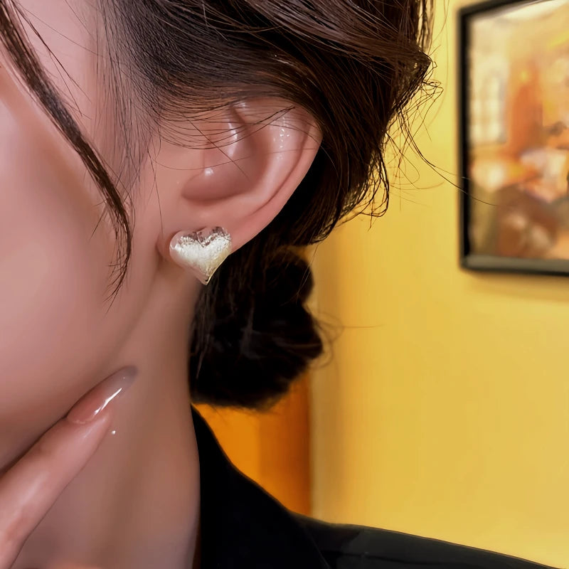 Close-up detail of the sparkling zircons and plating on the Silver Heart Studs