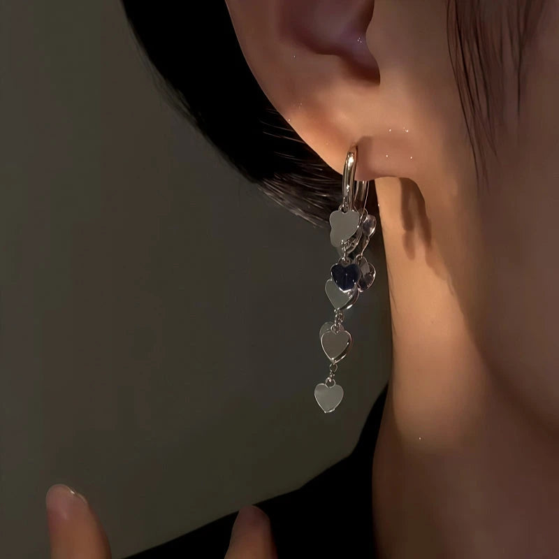 Model showcasing the dangle and style of the 14K Gold-Plated Elegant Heart Tassel Earrings