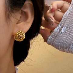 Close-up detail of the sparkling zircons and plating on the Hollow Basket Earrings