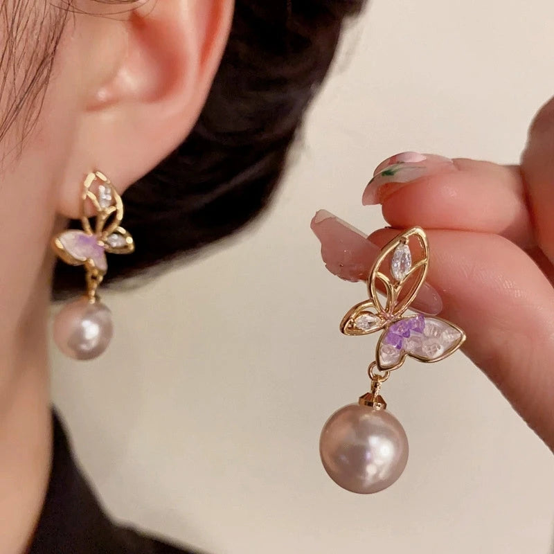 Angled view of the 14K Gold-Plated Elegant Hollow Butterfly Pearl Earrings
