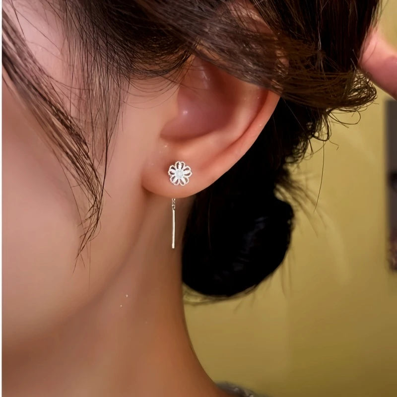 Angled view of the 14K Gold-Plated Elegant Hollow Filigree Flower Threader Earrings