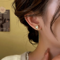 Model showcasing the dangle and style of the 14K Gold-Plated Elegant Hollow Flower Threader Earrings