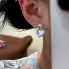 Close-up detail of the sparkling zircons and plating on the Hollow Heart Earrings