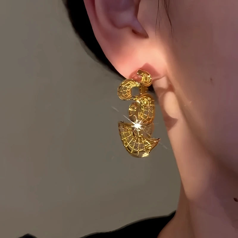 Close-up detail of the sparkling zircons and plating on the Wave Hoop Earrings