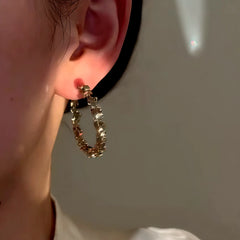Model showcasing the dangle and style of the 14K Gold-Plated Elegant Hoop Earrings