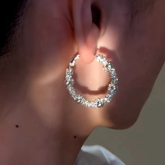 Model showcasing the dangle and style of the 14K Gold-Plated Elegant Hoop Earrings