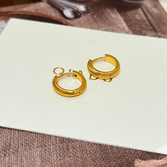 Model showcasing the dangle and style of the 14K Gold-Plated Elegant Hoop Earrings