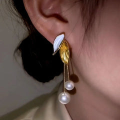 Close-up detail of the sparkling zircons and plating on the Leaf Pearl Tassel Earrings