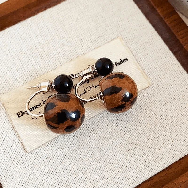 Angled view of the 14K Gold-Plated Elegant Leopard Print Bead Earrings