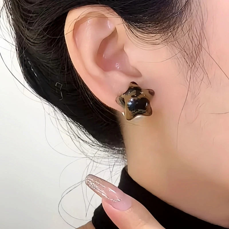 Close-up detail of the sparkling zircons and plating on the Leopard Print Star Earrings