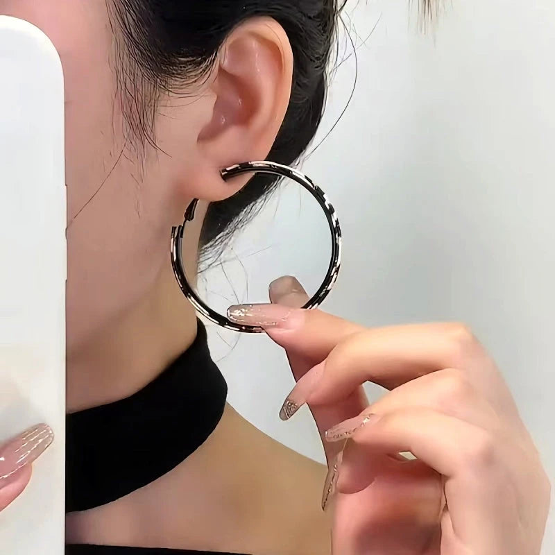 Model showcasing the dangle and style of the 14K Gold-Plated Elegant Leopard Print Hoop Earrings