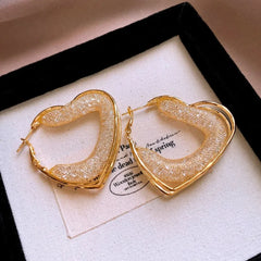 Angled view of the 14K Gold-Plated Elegant Mesh Heart-Design Earrings