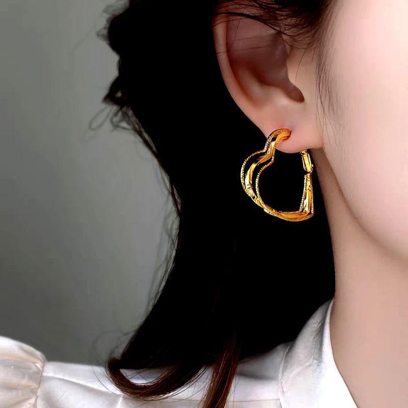 Angled view of the 14K Gold-Plated Elegant Multi-Layer Heart Earrings