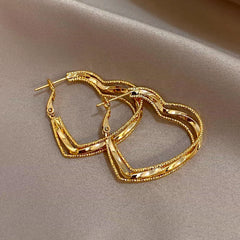 Close-up detail of the sparkling zircons and plating on the Multi-Layer Heart Earrings