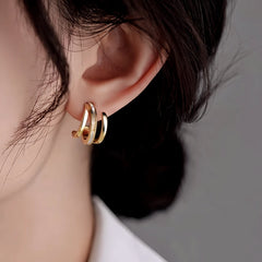 Model showcasing the dangle and style of the 14K Gold-Plated Elegant Multi-Layer Stud Earrings