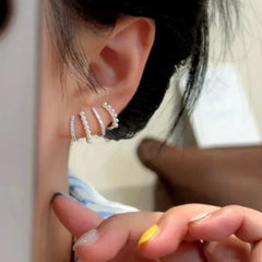 Model showcasing the dangle and style of the 14K Gold-Plated Elegant Multi-Layer Zircon Pearl Stud Earrings