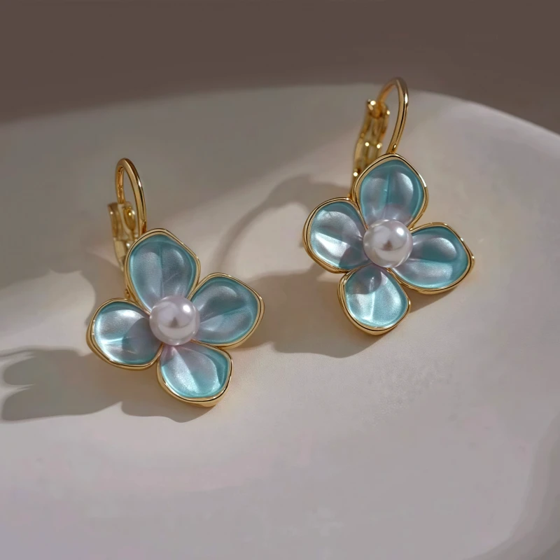Close-up detail of the sparkling zircons and plating on the Blue Flower Earrings