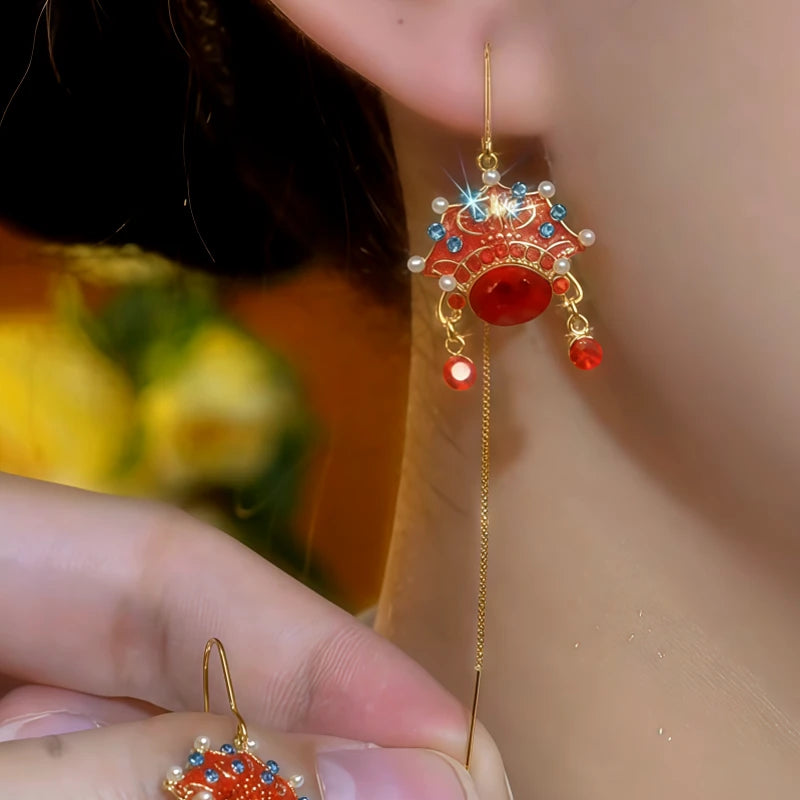 Model showcasing the dangle and style of the 14K Gold-Plated Elegant Opera Mask Threader Earrings