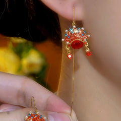 Model showcasing the dangle and style of the 14K Gold-Plated Elegant Opera Mask Threader Earrings