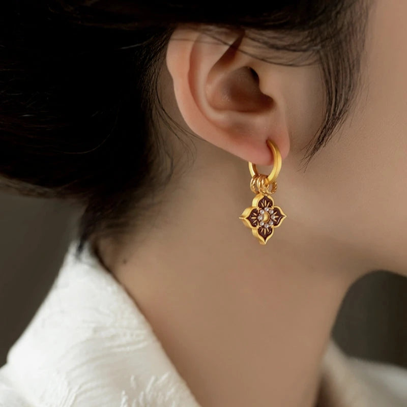 Model showcasing the dangle and style of the 14K Gold-Plated Elegant Painted Glazen Earrings