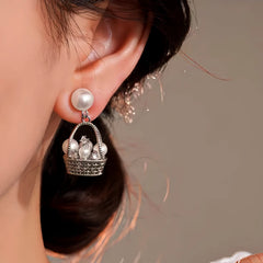 Close-up detail of the sparkling zircons and plating on the Pearl Basket Earrings