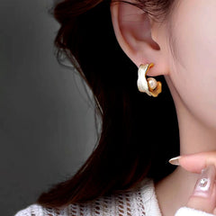 Model showcasing the dangle and style of the 14K Gold-Plated Elegant Pearl C-Shaped Earrings
