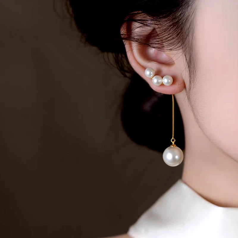 Model showcasing the dangle and style of the 14K Gold-Plated Elegant Pearl Tassel Earrings
